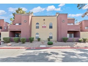 Attractive condo exterior with well-maintained landscaping and stucco siding in a desert community at 4050 Pacific Harbors Dr # 229, Las Vegas, NV 89121