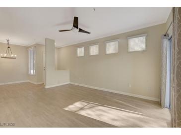 Bright living room with light wood floors, modern ceiling fan, and natural light from multiple windows at 4400 S Jones Blvd # 2103, Las Vegas, NV 89103