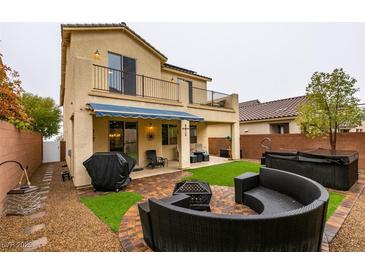 Inviting backyard space featuring a patio area with a fire pit, seating, and a relaxing hot tub at 7553 Old Compton St, Las Vegas, NV 89166