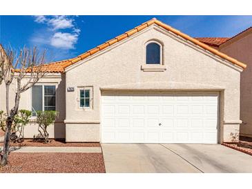 Inviting single-story home featuring a two-car garage and desert landscaping at 7628 Picnic St, Las Vegas, NV 89131