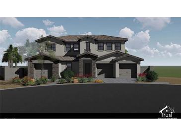 Two-story home featuring a stone-accented facade, tile roof, and a three-car garage, showcasing modern design and desert landscaping at 8 Rue Du Ville Way, Henderson, NV 89011