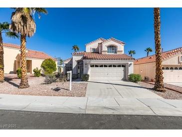 Charming two-story home with a well-maintained front yard and an attached two-car garage at 8012 Pottery Creek Dr, Las Vegas, NV 89128