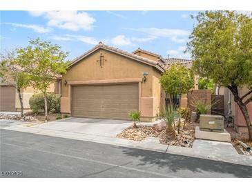 Charming single-story home featuring a two-car garage and well-maintained desert landscaping in front at 8942 Partridge Hill St, Las Vegas, NV 89148