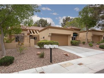 Charming single-story home with a well-manicured front yard and attached two-car garage at 9533 Yucca Blossom Dr, Las Vegas, NV 89134