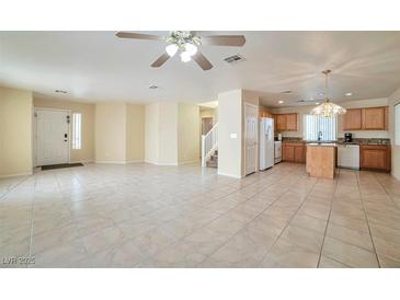 Spacious living room and open floorplan feature tile flooring and natural light at 9614 Orchard Oasis Ct, Las Vegas, NV 89147