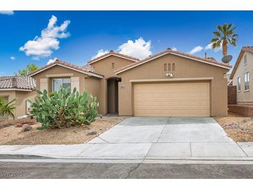 Charming single-story home showcasing desert landscaping and a two-car garage under a bright blue sky at 10513 Shanna Trellis Ave, Las Vegas, NV 89144