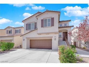 Charming two-story home featuring a large garage, neutral colors, manicured landscaping, and inviting front entrance at 10973 Sardinia Sands Dr, Las Vegas, NV 89141