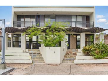 Striking two-story multi-Gathering home featuring a unique entrance and covered balconies on both levels at 214 S Maryland Pkwy, Las Vegas, NV 89101