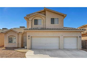 Two story home with a three-car garage and light tan exterior at 2435 Paddock Ln, Las Vegas, NV 89156