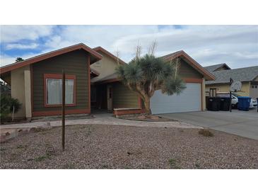 Charming single-story home with desert landscaping, a two-car garage, and a neutral color scheme at 3115 Floral Vista Ave, Henderson, NV 89014