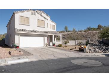 Charming two-story home with a two-car garage and a well-maintained front yard with desert landscaping at 3169 Crystal Moon Rd, Henderson, NV 89052