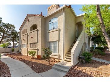 Charming condo exterior with stucco siding, terra cotta roof, and inviting front entrance with landscaped walkway at 4316 W Lake Mead Blvd # 202, Las Vegas, NV 89108