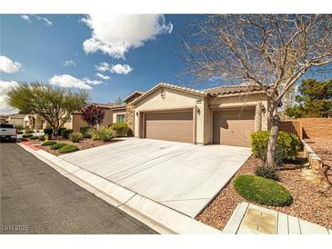 Inviting single-story home featuring a well-manicured lawn, desert landscaping, and a spacious three-car garage at 5224 E San Palo Dr, Pahrump, NV 89061