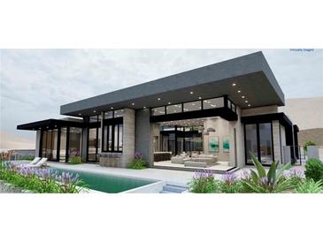 Modern home exterior with pool, patio, large windows, and desert landscaping at 563 Rock Peak Dr, Henderson, NV 89012