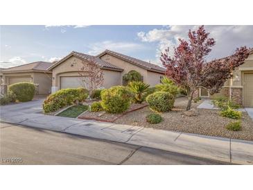 Charming single-story home with a desert landscape and a well-maintained front yard at 6076 Wheat Penny Ave, Las Vegas, NV 89122