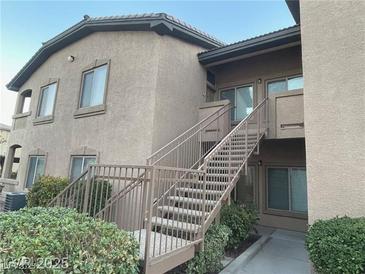 Exterior shot of a two-story condo building with well-maintained landscaping at 8985 S Durango Dr # 2043, Las Vegas, NV 89113