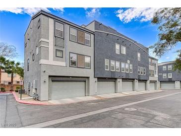 Modern townhome exterior featuring a private garage and contemporary architectural design at 9050 W Tropicana Ave # 1080, Las Vegas, NV 89147