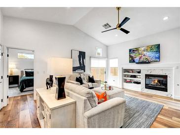 Inviting living room featuring a modern fireplace, ceiling fan, and stylish decor at 228 Mchenry St, Las Vegas, NV 89144