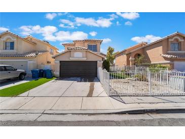 Charming two-story home with a two-car garage, low maintenance front yard, and desert landscaping at 2211 Arborwood Way, Las Vegas, NV 89142