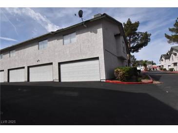 Spacious townhouse with attached garages and well-maintained landscaping at 2431 Old Forge Ln # 101, Las Vegas, NV 89121
