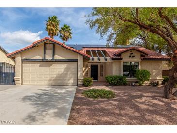 Charming single-story home with a well-manicured yard, desert landscaping, and a two-car garage at 2842 Mahogany Grove Ave, Henderson, NV 89074