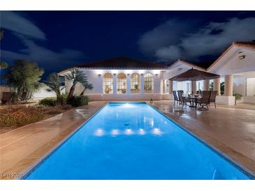 Stunning backyard pool with elegant seating area perfect for evening entertaining, set against a modern home exterior at 3240 W Richmar Ave, Las Vegas, NV 89139