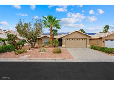 Charming single-story home with desert landscaping and a two-car garage on a sunny day at 36 Trailside Ct, Henderson, NV 89012