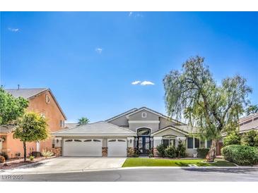 Charming single-story home boasts a three-car garage and well-maintained landscaping at 5641 Morning Snow Ct, Las Vegas, NV 89141