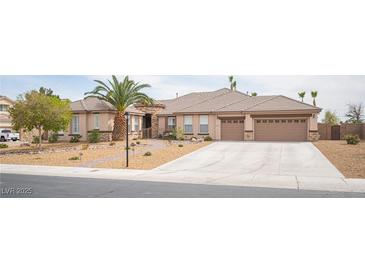 Lovely single-story home boasting desert landscaping, a tile roof, and a spacious three-car garage at 5815 Pristine Falls Ave, Las Vegas, NV 89131