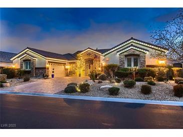 Charming home featuring a brick driveway, manicured landscaping, and elegant exterior lighting at 6373 Bridal Cave Ave, Las Vegas, NV 89131