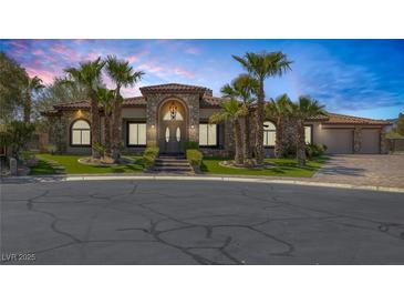 Charming single-story home with lush landscaping and a beautiful stone facade at 7687 W Pebble Rd, Las Vegas, NV 89113