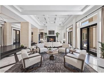 Bright living room with fireplace, high ceilings and elegant decor at 9 Greely Club Trl, Henderson, NV 89052