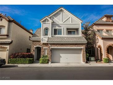 Charming two-story home boasts stone accents and a well-manicured front yard at 9173 Whitekirk Pl, Las Vegas, NV 89145