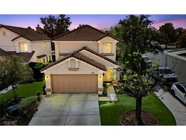 Charming two-story home with a well-manicured lawn, attached garage, and inviting curb appeal at 9409 Kayla Ct, Las Vegas, NV 89134