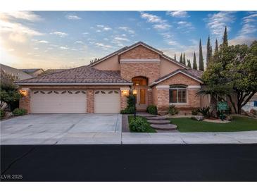 Charming single-story home featuring a three-car garage, manicured landscaping, and a welcoming entrance at 1501 Via Salaria Ct, Henderson, NV 89052
