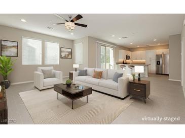 Bright, open-concept living room featuring modern furniture, neutral tones, and seamless flow into the kitchen at 11236 Rainbow Peak Ave # 210, Las Vegas, NV 89135