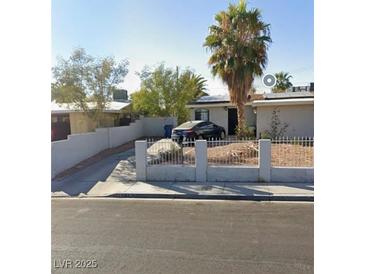 Charming single-story home with mature landscaping, and a concrete fence at 1804 David Ave, Las Vegas, NV 89101