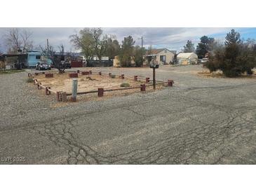 A gravel lot with a framed area and several mobile homes in the background on an overcast day at 2341 Shady Ln, Pahrump, NV 89060