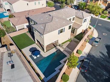 Stunning aerial view of a home with a private pool and landscaped backyard with artificial turf at 3062 Echoed Rondel Ln, Henderson, NV 89044