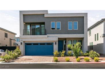 Modern two-story home featuring a blue garage door, minimalist landscaping, and a small second story balcony at 363 Terrill Ave, Las Vegas, NV 89183