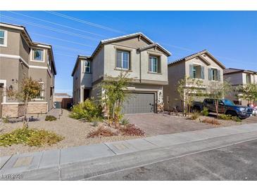Charming two-story home featuring a brick driveway, attached two-car garage and low maintenance landscaping at 4066 Painted Lady Ave, Las Vegas, NV 89141