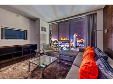Chic living room featuring modern furnishings and a stunning city view through floor-to-ceiling windows at 4381 W Flamingo Rd # 2308, Las Vegas, NV 89103
