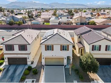 Two-story stucco home with a tile roof, two car garage, and desert landscaping at 5667 Foxglove Field St, Las Vegas, NV 89130