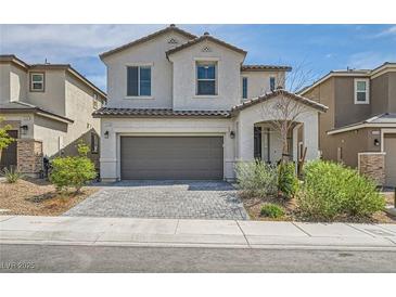 Charming two-story home featuring a two-car garage, landscaped yard, and a welcoming front porch at 6338 Selston Dr, North Las Vegas, NV 89081