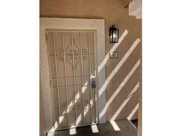 Inviting front door with security screen and modern exterior lighting, creating a secure entrance at 830 Carnegie St # 1811, Henderson, NV 89052