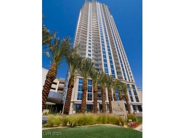 Elegant high-rise building with modern architecture and beautiful landscaping features, including palm trees at 200 W Sahara Ave # 3412, Las Vegas, NV 89102