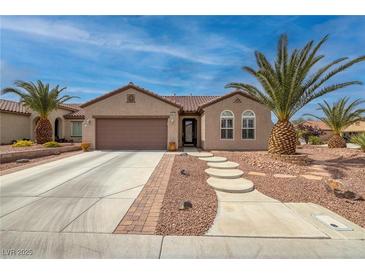 Charming home featuring beautiful desert landscaping, a two-car garage, and a stylish, tiled roof at 2217 Merrimack Valley Ave, Henderson, NV 89044
