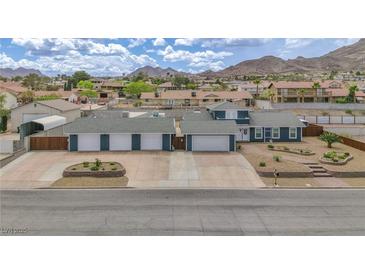 Inviting single-story home with blue siding, four-car garage and mountain views at 261 W Cypress Dr, Henderson, NV 89015