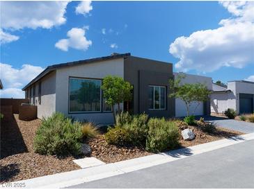Well-manicured front yard with desert landscaping and modern two-tone exterior at 4557 E Cactus Canyon Dr, Pahrump, NV 89061