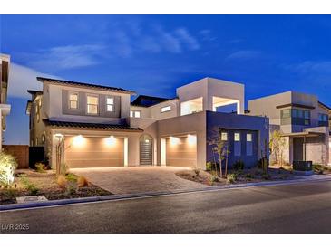 Stunning modern home showcasing a three-car garage and landscaped front yard with a paved driveway at 472 Windstone Crest Ave, Las Vegas, NV 89138